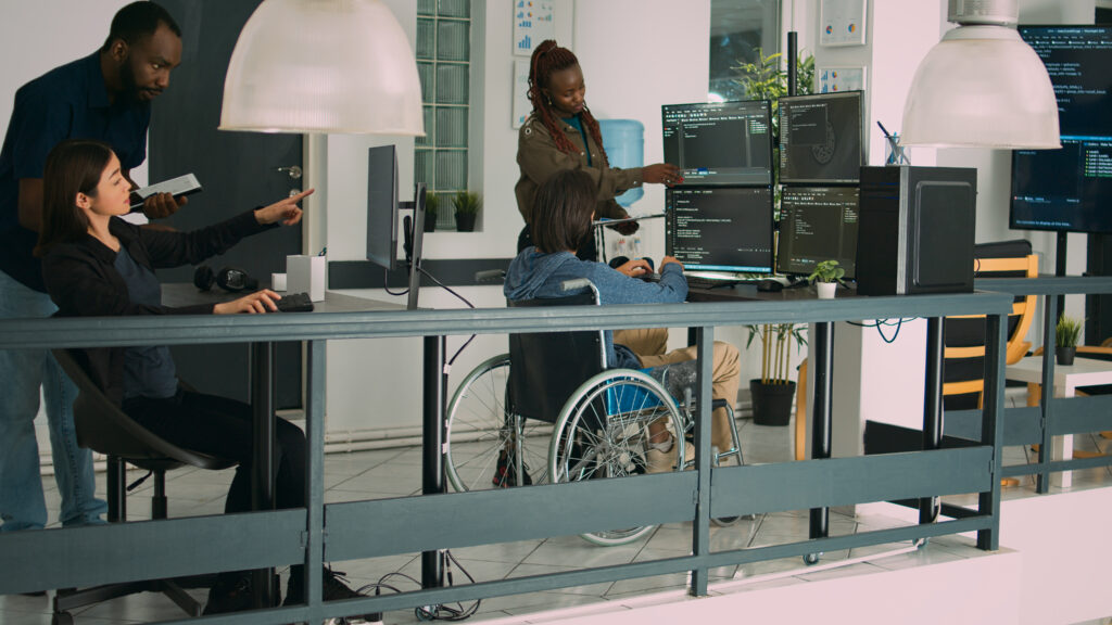 asian coder with physical disability working with african american developer